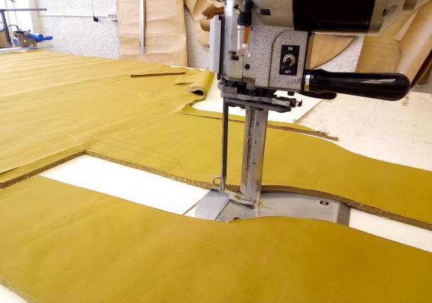 istockphoto-1312828539-612x612 Tool cutter in the garment industry. Cutting parts of clothing with an electric knife made of multi-layer fabric.